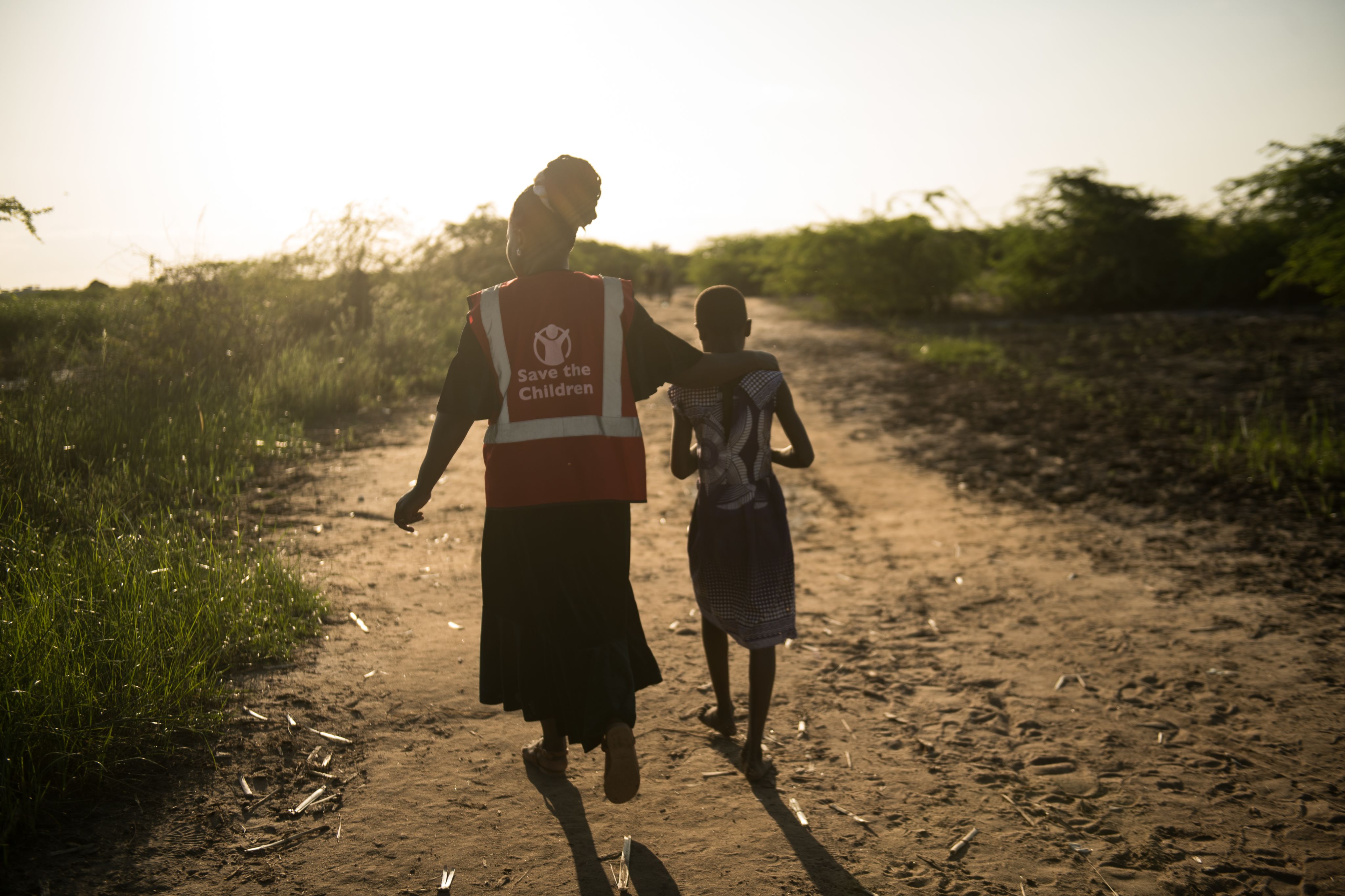 Sarah*, 11, with her Save the Children child protection officer, Daisy