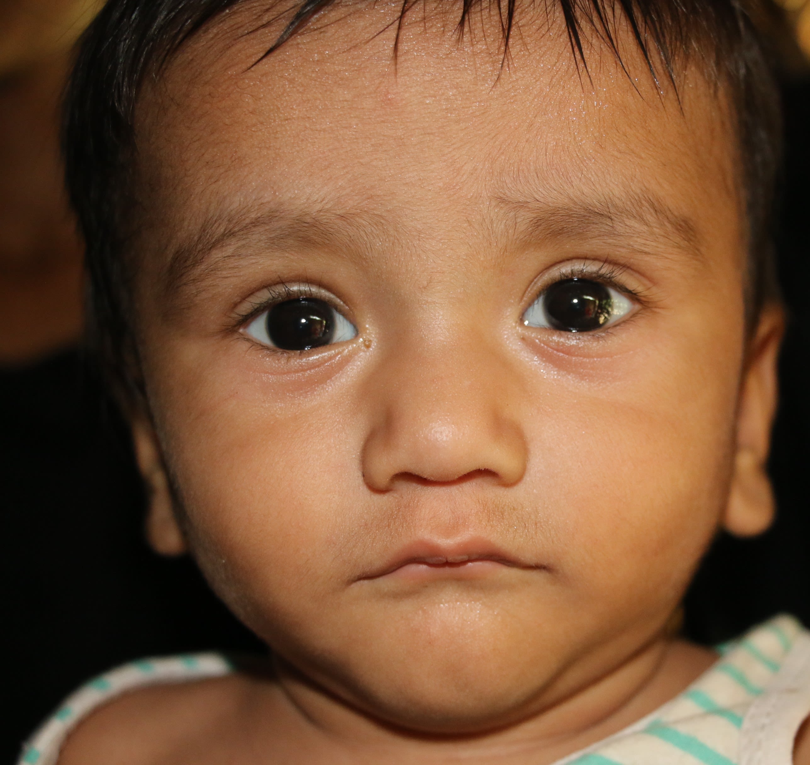 Sabbir*, (11 months) plays with a toy at his home in Cox's Bazar, Bangladesh