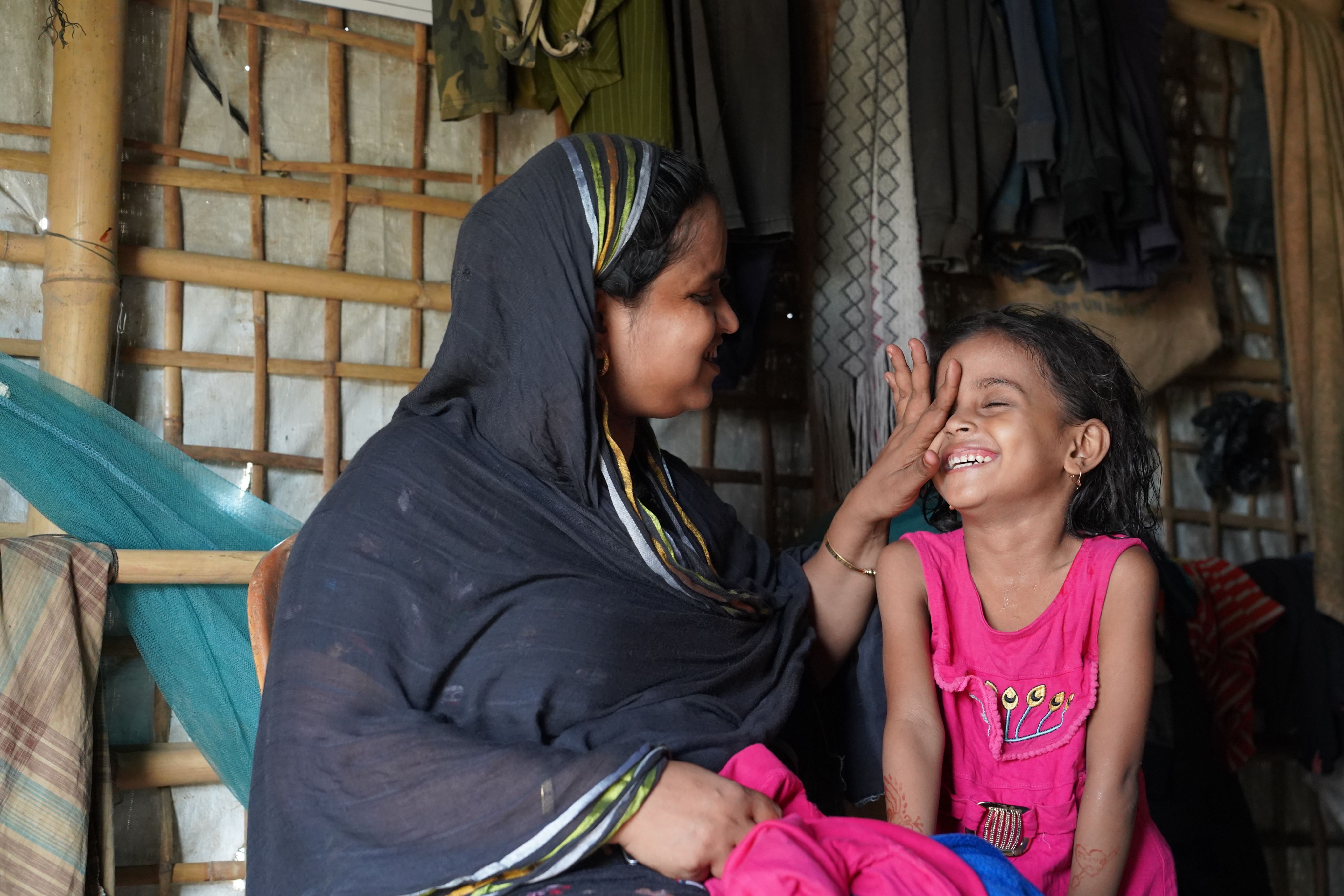 A portrait of Antora*, 5, at her house in Cox's Bazar, Bangladesh.